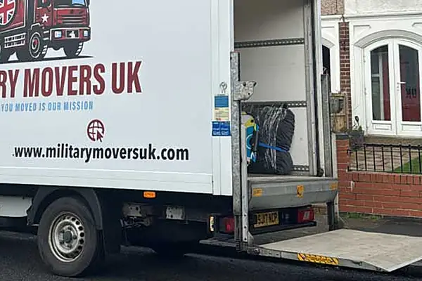 Military Movers UK Luton van with its tail lift lowered outside a house