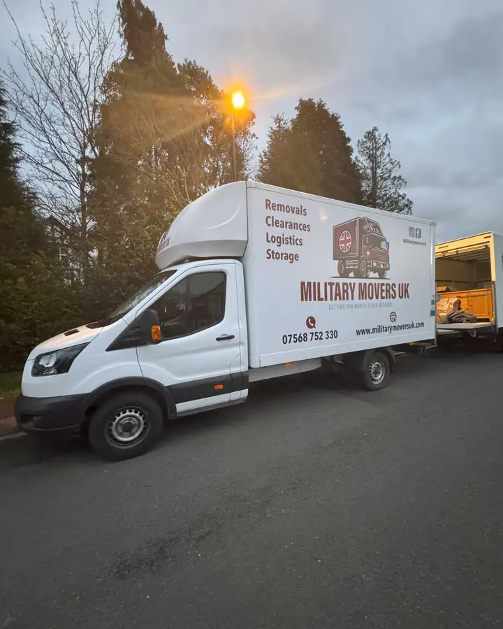 Military Movers UK Luton van parked on a residential road at dusk