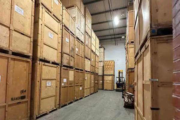 Wooden storage containers stacked in a secure warehouse used by Military Movers UK